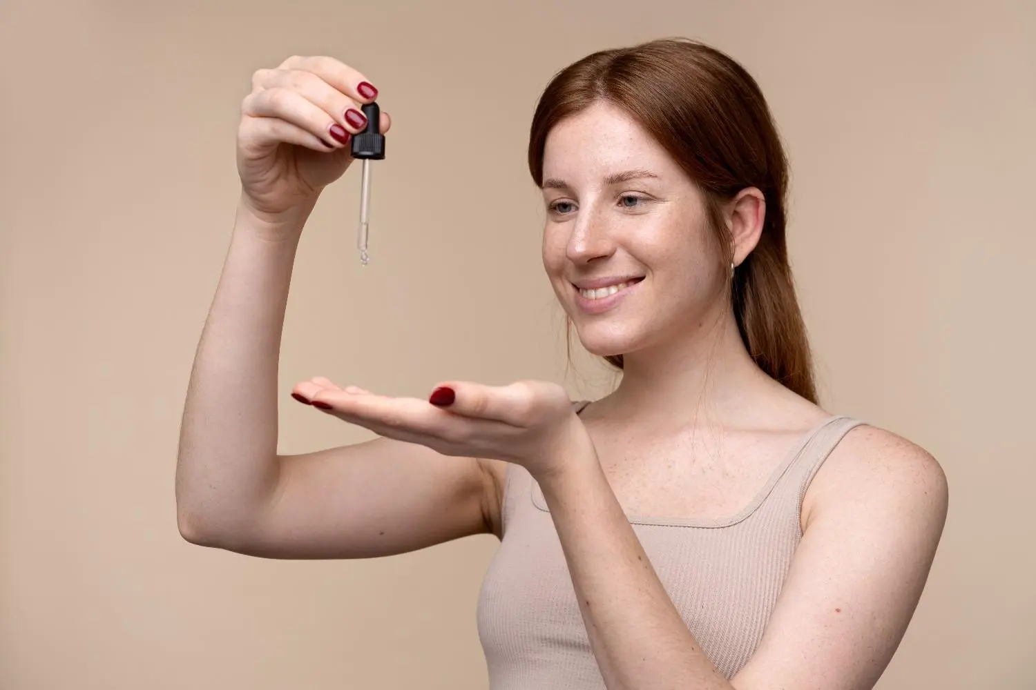 Patient applying skincare serum for a guide to choosing acids by skin type and concern